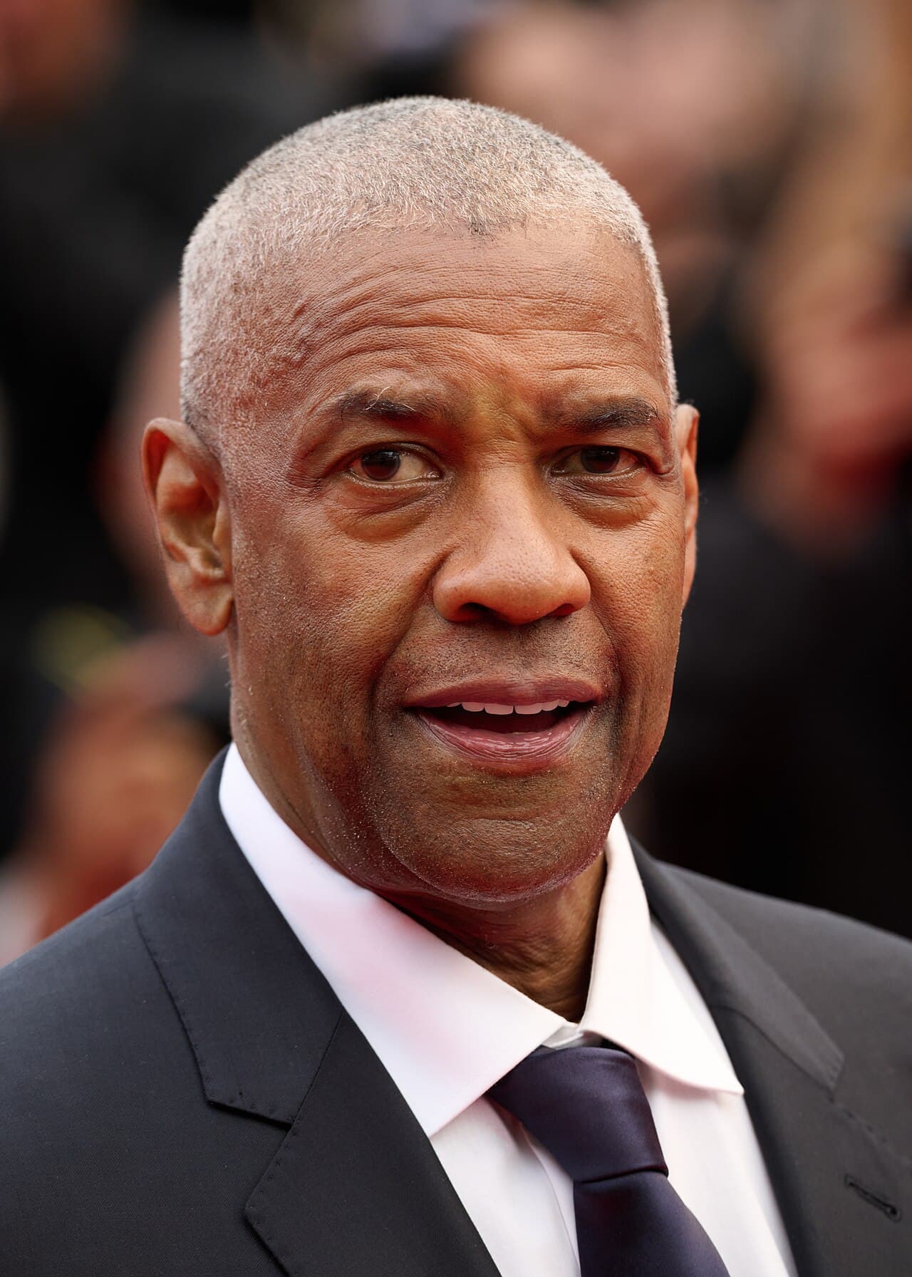 Denzel Washington attending prestigious international film premiere in sharp formal attire